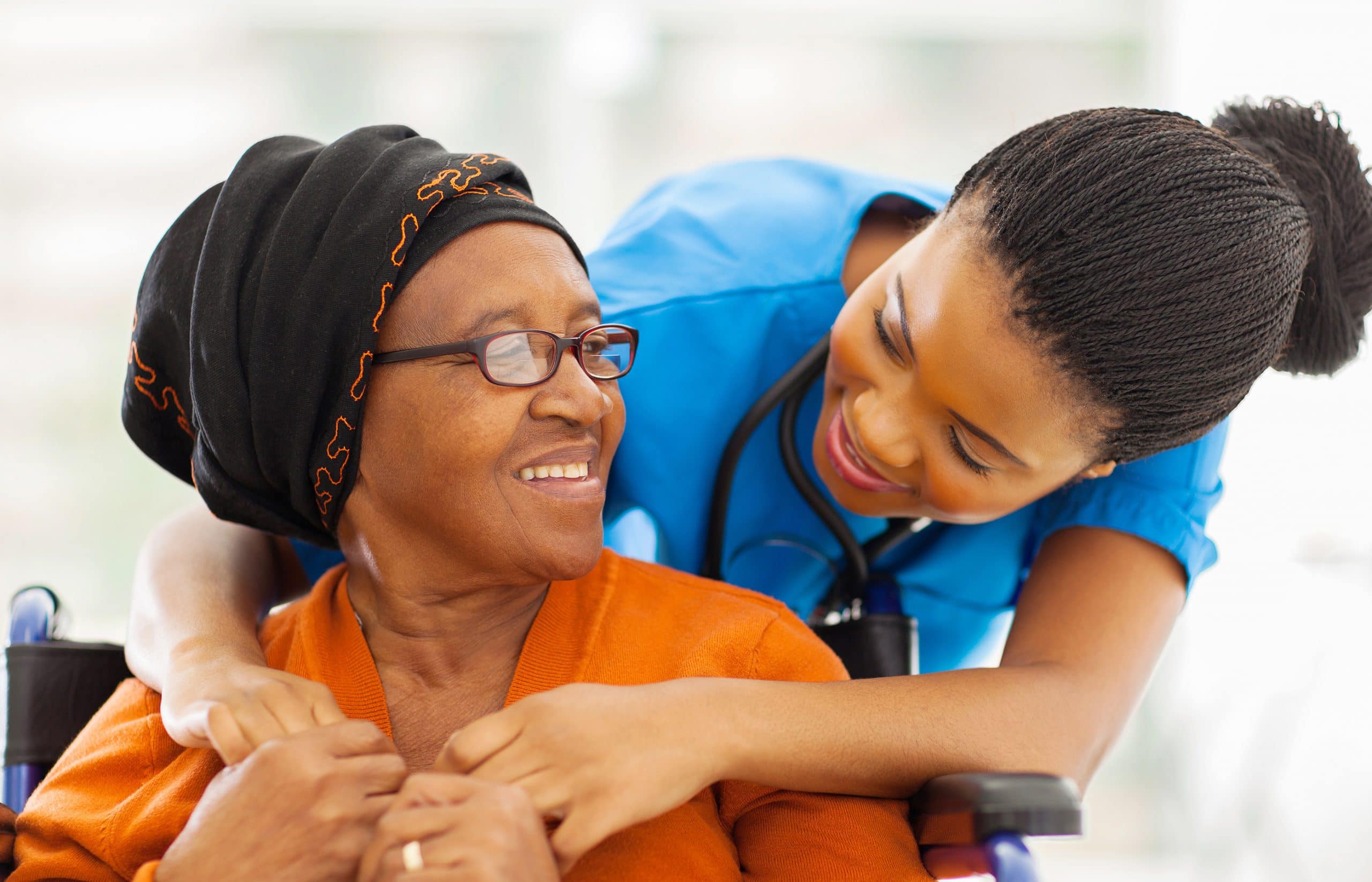 Caregiver assisting elderly woman
